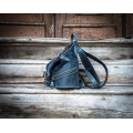 leather backpack in navy blue color with comfortable zippered pocket on the back